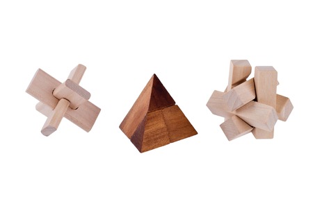 Wooden brain teasers on white background 