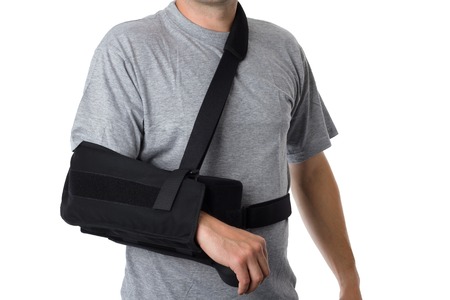 Man wearing an arm brace over whiteの写真素材