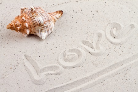 Word love written in the sandの写真素材
