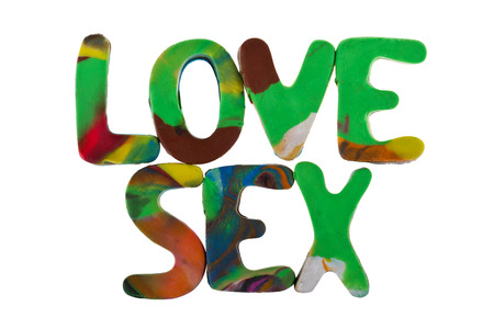 Sex and love spelled out using colored plasticineの写真素材