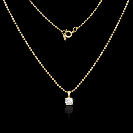 Golden necklace isolated on black backgroundの写真素材
