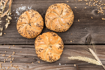 Rustic bakery and wheat on an old vintage planked wood table.の写真素材