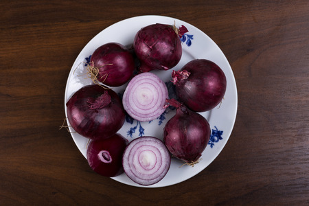 Red onion on a white plateの写真素材