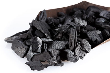 Pile of charcoal and shovel isolated on whiteの写真素材