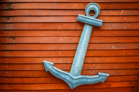 Wooden nautical anchor on wooden backgroundの写真素材