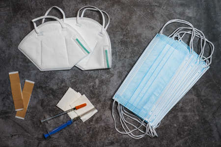 Medical mask, respirator masks FFP2 and syringe on black background.  vaccination.  vaccine concept.