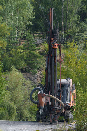 Drilling machine in open cast mining quarry. Mining industry.