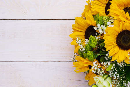 Wedding bouquet of sunflower on a wooden background. Top view with copy space.の写真素材