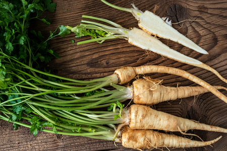 Heap roots parsley with leaves on wooden backgroundの写真素材