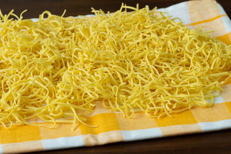 Dry homemade soup noodles. Raw small noodles.