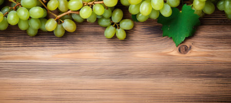 Green juicy grapes on wooden background.の素材