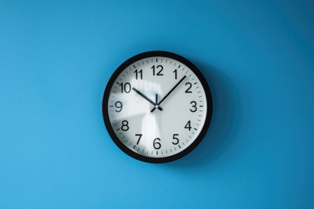 Vintage wall clock on a blue backgroundの素材