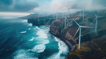 Wind turbines against a sunrise coastal landscapeの素材