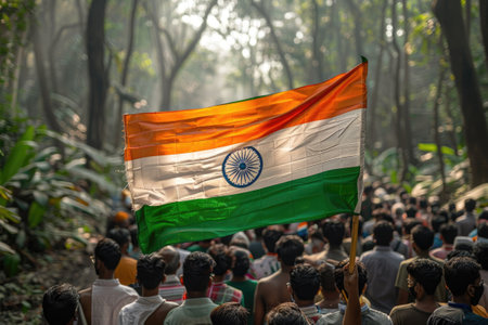 Group of people holding Indian flag in a forested area during the dayの素材