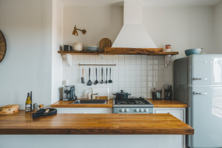 Bright, modern kitchen showcases wooden countertops, white tile backsplash, and a stylish retro refrigeratorの素材