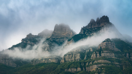 Fog is covering the Montserrat mountain range near Barcelona, Catalonia, Spain, on a moody dayの素材