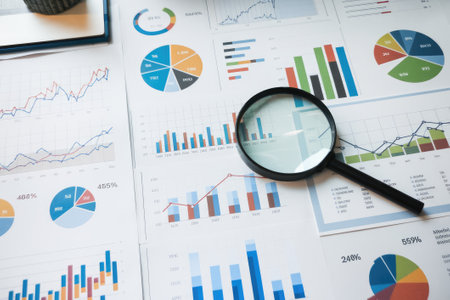 Magnifying glass is used to analyze business charts, graphs, and financial data, providing insights for market research and investment decisionsの素材