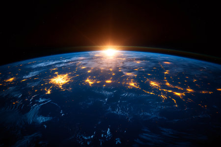 Planet earth rotating showing city lights and sun shining from spaceの素材