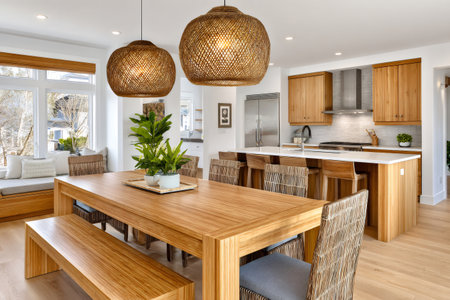 Bright open concept kitchen and dining room showcasing natural materials, woven light fixtures, and a modern designの素材