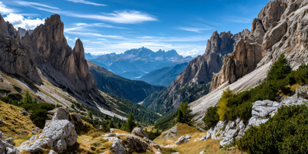 Dolomites mountains revealing valley and rugged landscape under blue skyの素材