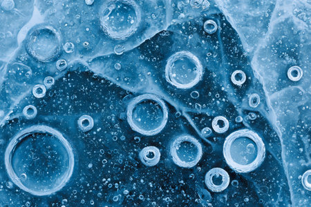 Blue ice showing abstract texture with entrapped round air bubblesの素材