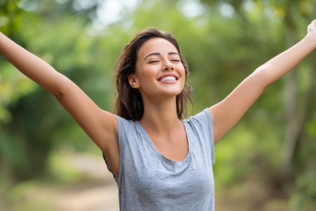 Woman feeling happy and free outdoors, enjoying a moment of peace and fresh airの素材