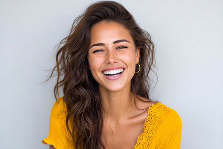 Happy brunette woman laughing, showing joy and positive emotionの素材