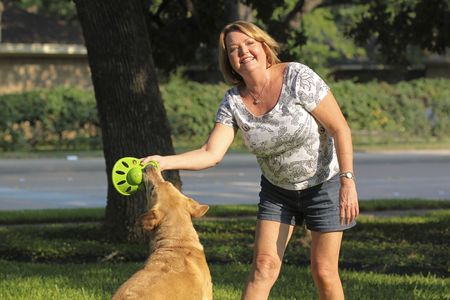 Mature woman playing with her dog.の写真素材