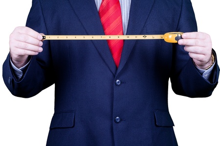 Businessman in suit and red tie measuring success.の写真素材