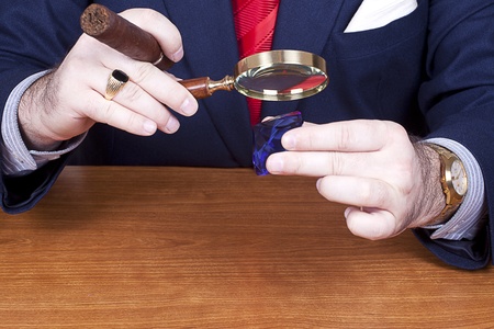 Businessman looking at a diamond.