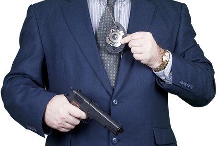 Police office with gun and badge in actionの写真素材
