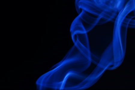 Real blue smoke on black background の写真素材