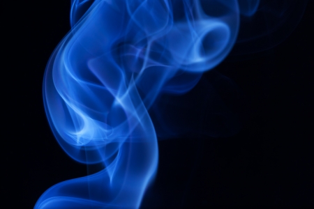 Real blue smoke on black background の写真素材