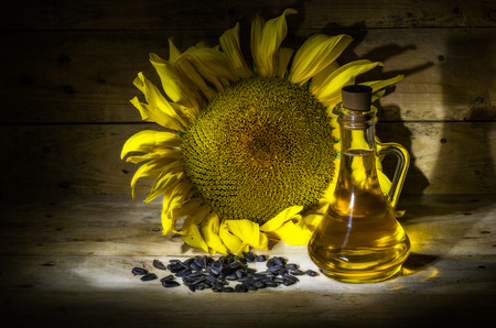 still life with sunflowers, sunflower oil and seedsの写真素材