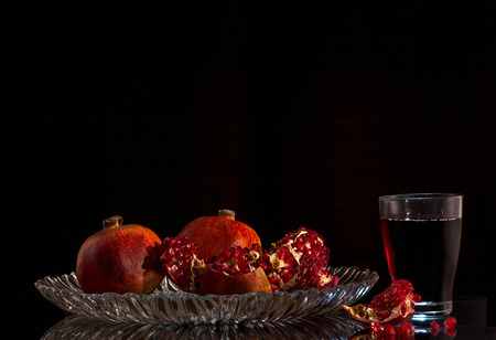 Ripe pomegranates with juice on table close-upの写真素材