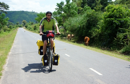 Traveller ride bicycle on the road conect Dalat to Daklak, this is the nice road with fresh air, neglected landcape  Viet Nam- September 3, 2013のeditorial素材