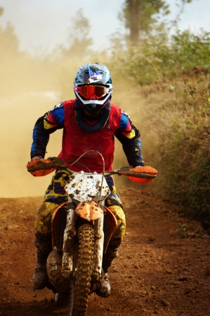 The motorcycle race hole on December at Dambri waterfall, motorcyclist try to speed up goal, red soil way, indistinct dustのeditorial素材
