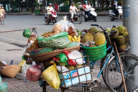 SAI GON, VIET NAM- JULY 21: Fruit store of street vendor on bicycle, Sai Gon, Viet Nam on July 21, 2013のeditorial素材