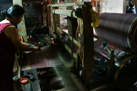  People weave striped cloth by power loom at home in Dong Thap, Viet Nam on Nov 15, 2013のeditorial素材