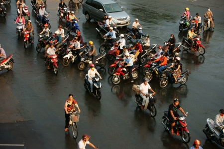 HO CHI MINH, VIET NAM, ASIA- NOV 22: Group of people wear helmet, ride motorbike moving on street in rush hour, they pass by make chaotic traffice in Ho Chi Minh city, Vietnam, Asia on Dec 15, 2012のeditorial素材