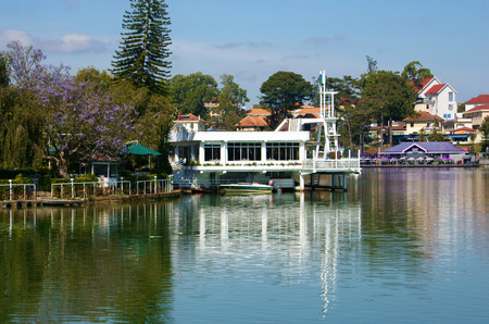 DALAT, VIETNAM- FEB 1  Thuy Ta restaurant reflect on water of Xuan Huong lake in day, a floating house with ancient architecture and tree around, famous for travel, Da Lat city, Viet Nam, Feb 1, 2014のeditorial素材