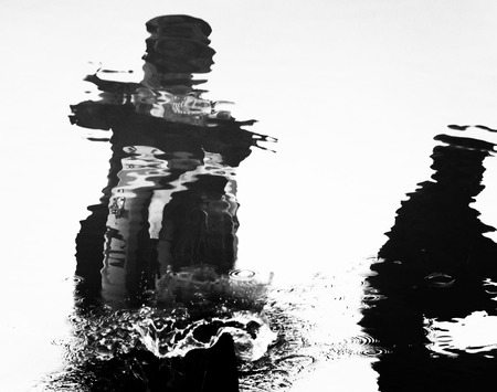 Virtual image, reflection silhouette of man riding motorbike on water, splash water                         の写真素材