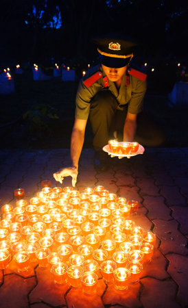 HO CHI MINH CITY , VIETNAM- JULY 26: People hold candle in July 27 event, ceremony to commenorate heroic that sacrifice in Vietnam war at martyr cemetery, Viet Nam, July 26, 2014のeditorial素材