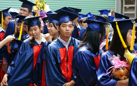 HO CHI MINH CITY, VIETNAM- AUG 8   Group of student in gown uniform standing, wait for graduate ceremony at university, young human resources worryl face to unemployed situaion, Viet Nam,  Aug 5, 2014のeditorial素材