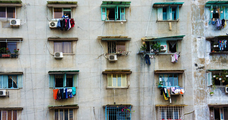 HO CHI MINH CITY, VIET NAM- SEPT 11: Impression scene of cement wall from old apartment building, group of aged window, air conditioner, block downgrade make unsafe, danger, Vietnam, Sept 11, 2014のeditorial素材