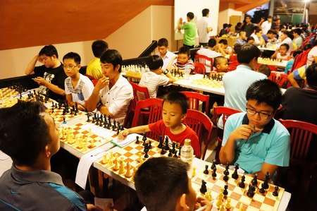 HO CHI MINH CITY, VIET NAM- OCT 5: Group of Asian children in chess compete, Vietnamese kid think with high concentration, entertainment sport to grow intelligence, make fun, Vietnam, Oct 5, 2014のeditorial素材