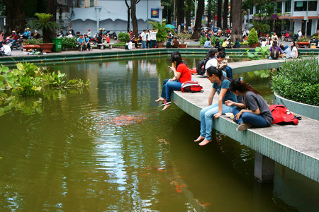 HO CHI MINH CITY, VIET NAM- OCT7: Lifestyle of young Asian people at urban, group of teenager sitting at Ho Con Rua to relax, talk with friend, fresh air in evening, amazing scene, Vietnam, Oct7, 2014のeditorial素材