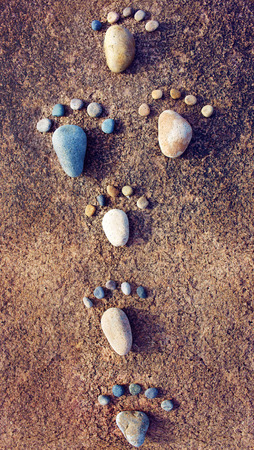 Amazing concept from stone, group of pebble as family illustration, foot step on rock, funny toe, pretty idea for designの写真素材