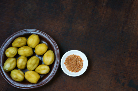 Vietnamese food, delicious snack, from ambarella or Spondias mombin, soak in syrup about 2 days, eat with salt, it taste sour, sweet, brittleの写真素材