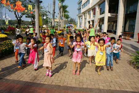 HO CHI MINH CITY, VIET NAM- FEB12: Group of unidentified Asian kid with outdoor activity of preschool, little boy, girl in uniform, Vietnamese children visit park in springtime, Vietnam, Feb 12, 2015のeditorial素材